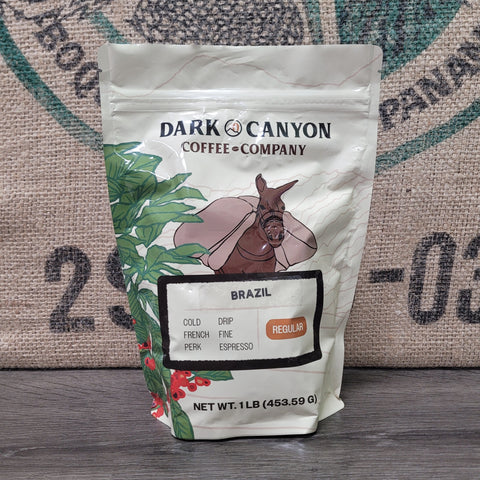 Brazil coffee 1lb package from Dark Canyon Coffee Company on a rustic background