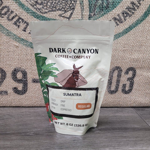 Dark Canyon Coffee Company Sumatra coffee bag on a wooden surface
