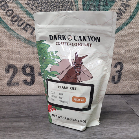 Dark Canyon Coffee Company coffee bag of flame kist on a wooden surface