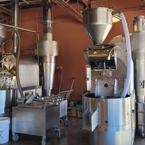 Large industrial coffee roasting machine in a warehouse setting