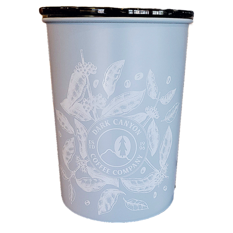 light blue one pound airscape coffee canister with white printed coffee plant design and circle dark canyon coffee logo