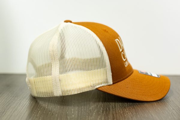 pumpkin and khaki colored Richardson snapback trucker hat with vertical stack alternative dark canyon coffee logo right side