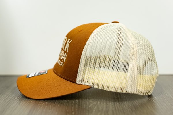 pumpkin and khaki colored Richardson snapback trucker hat with vertical stack alternative dark canyon coffee logo left side